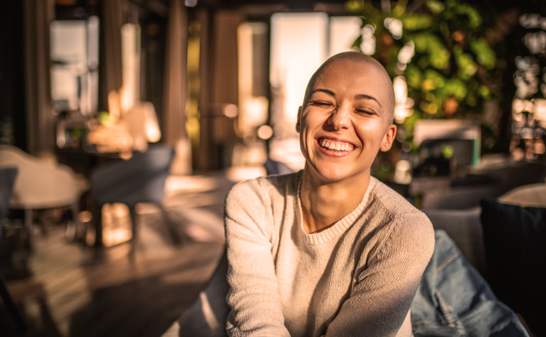 grinning-person-with-shaved-head